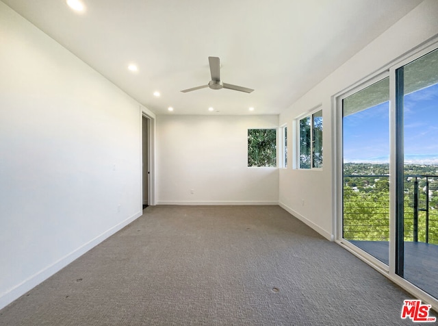 spare room featuring ceiling fan and carpet