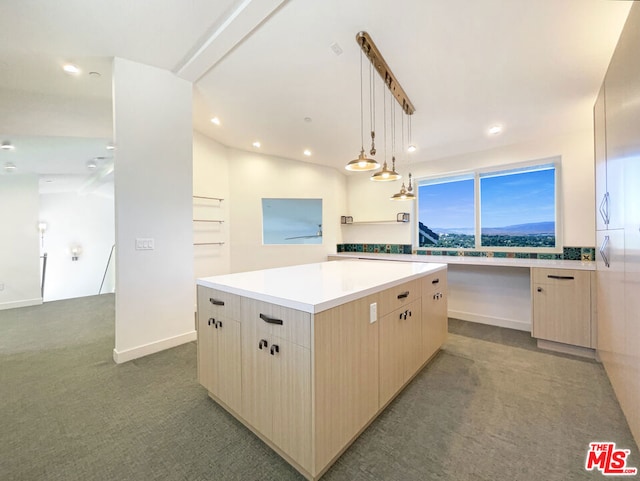 kitchen with carpet flooring, light brown cabinetry, decorative light fixtures, and a kitchen island