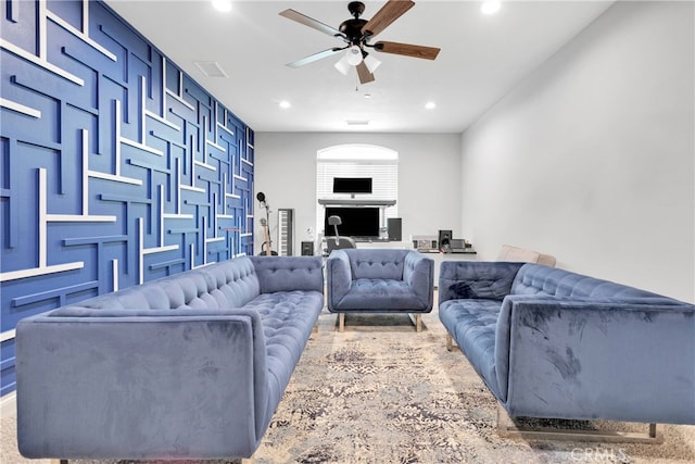 carpeted living room with ceiling fan