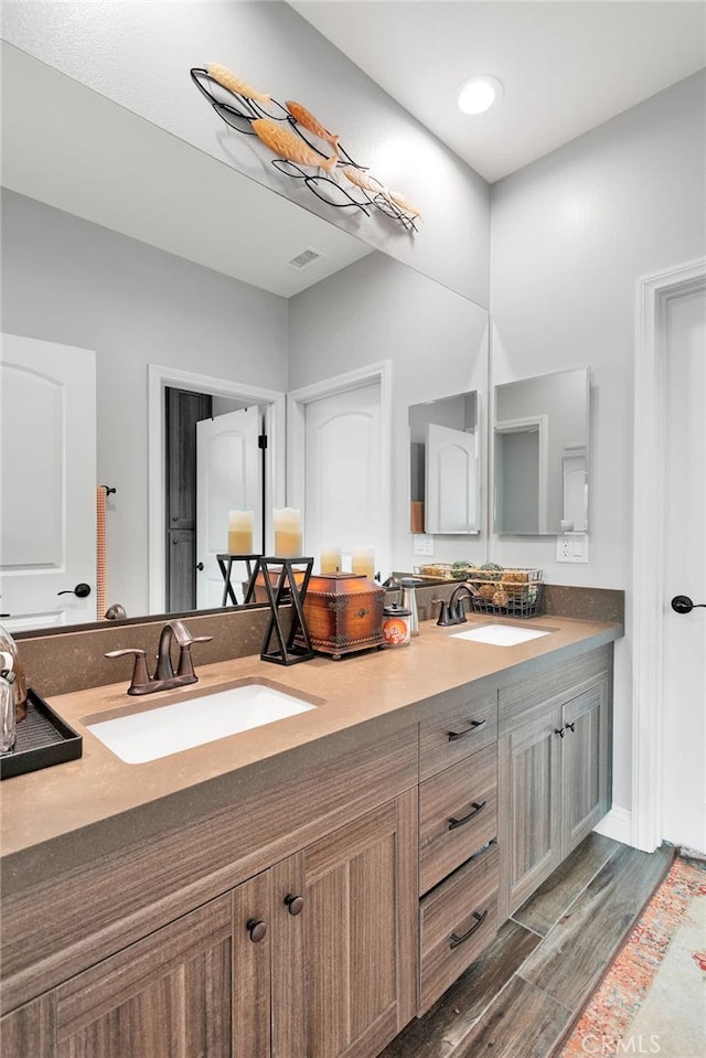 bathroom featuring vanity and hardwood / wood-style flooring