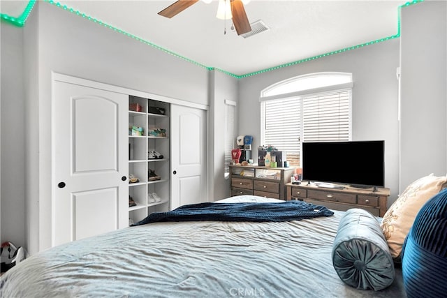 bedroom with ceiling fan and a closet