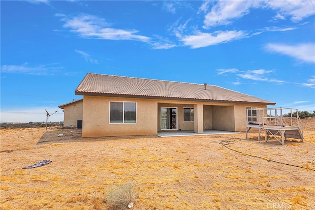 back of property with a patio