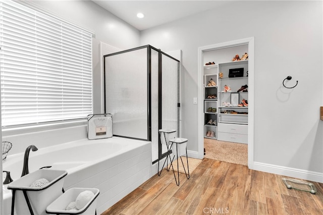 bathroom with separate shower and tub and hardwood / wood-style flooring