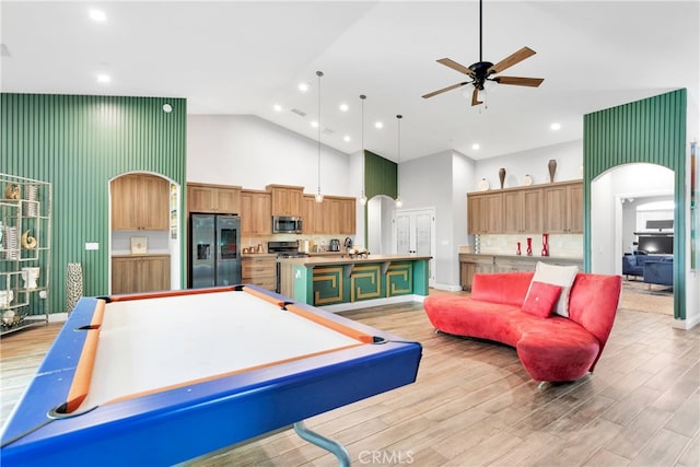 game room with ceiling fan, light wood-type flooring, pool table, and high vaulted ceiling