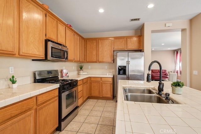 3688 Alhambra Ln, Perris, CA 92571 - kitchen featuring stainless steel appliances, tile counters, recessed lighting, and light tile patterned flooring