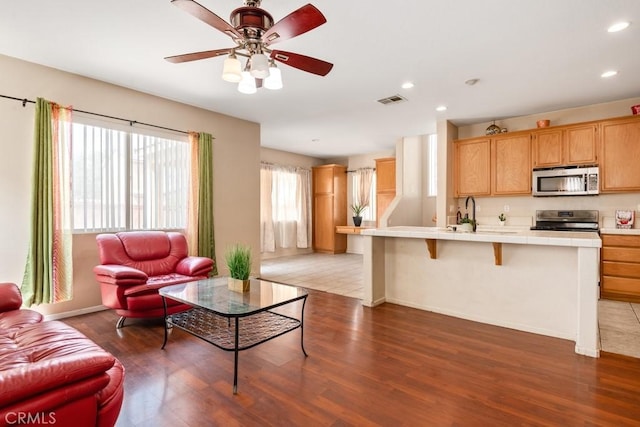 3688 Alhambra Ln, Perris, CA 92571 - living room with wood finished floors, ceiling fan, and recessed lighting