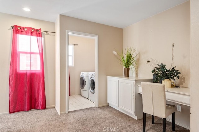 clothes washing area with light colored carpet and washer and dryer