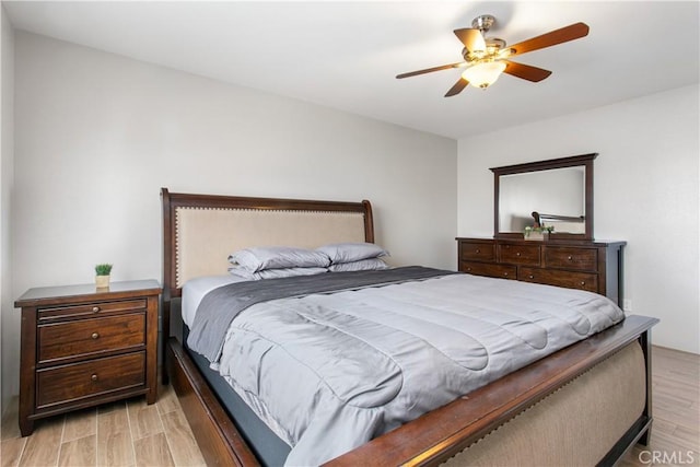 bedroom with ceiling fan and light hardwood / wood-style floors