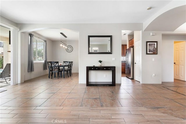 kitchen with stainless steel refrigerator and decorative light fixtures