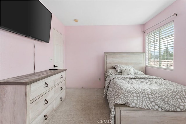 bedroom featuring light colored carpet