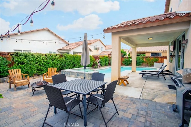 view of patio / terrace featuring a fire pit and a fenced in pool