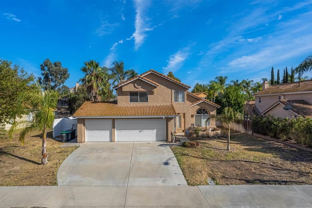 view of property featuring a garage and a front lawn