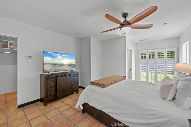 bedroom with ceiling fan, a closet, and light tile patterned floors