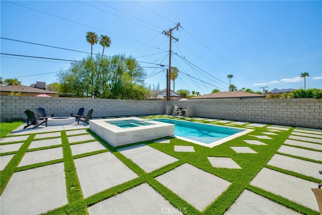 view of pool featuring an in ground hot tub, a fire pit, and a patio area