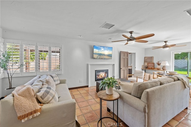 tiled living room featuring ceiling fan