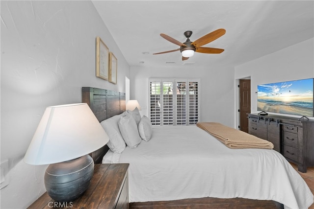 bedroom with ceiling fan and hardwood / wood-style floors