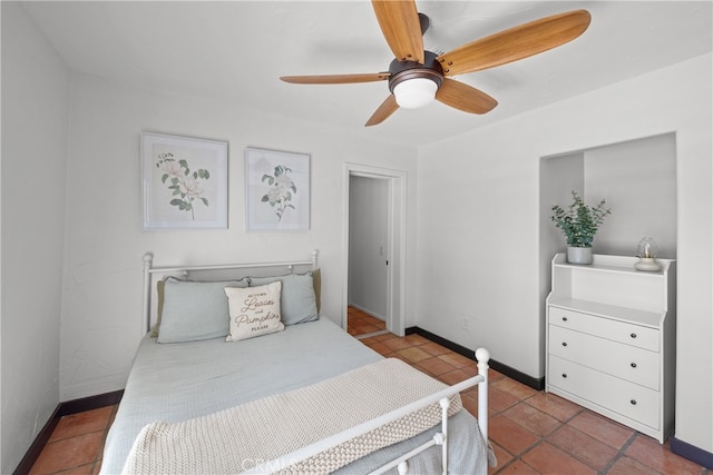 bedroom with ceiling fan and tile patterned floors