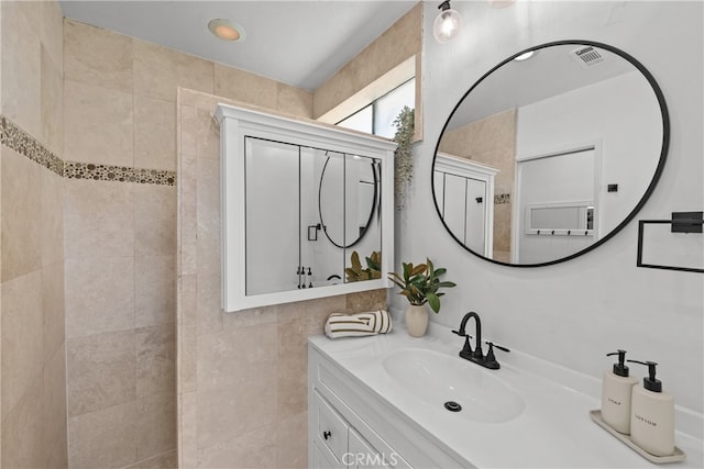 bathroom featuring vanity and tile walls