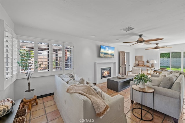 tiled living room featuring ceiling fan