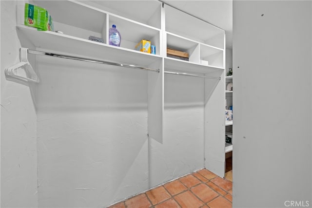 spacious closet with light tile patterned floors