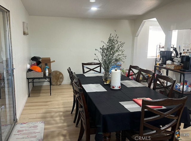 dining space with wood-type flooring