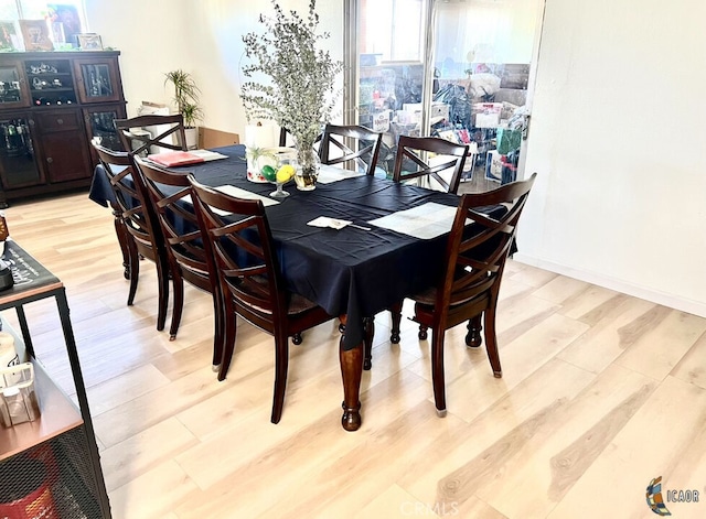 dining space with light hardwood / wood-style floors