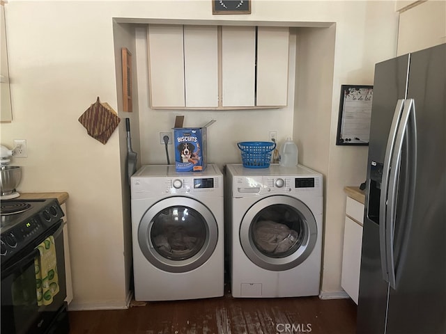 laundry room featuring washer and clothes dryer and dark hardwood / wood-style flooring