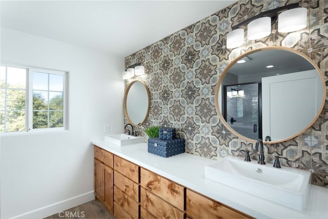 bathroom featuring hardwood / wood-style flooring, walk in shower, and vanity