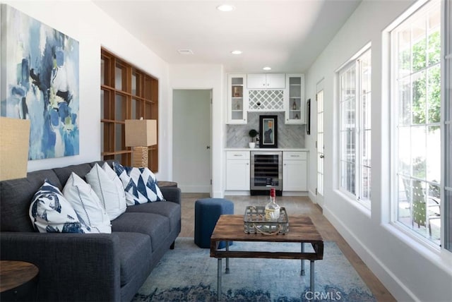 living room with beverage cooler and light wood-type flooring