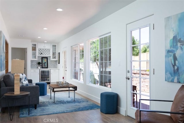 living area with light hardwood / wood-style flooring and wine cooler