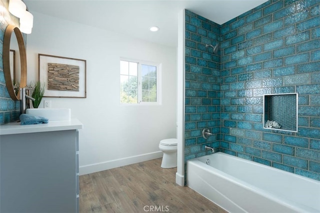 full bathroom featuring vanity, hardwood / wood-style flooring, bathtub / shower combination, and toilet