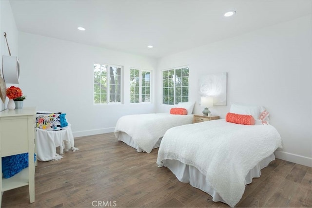 bedroom with dark wood-type flooring