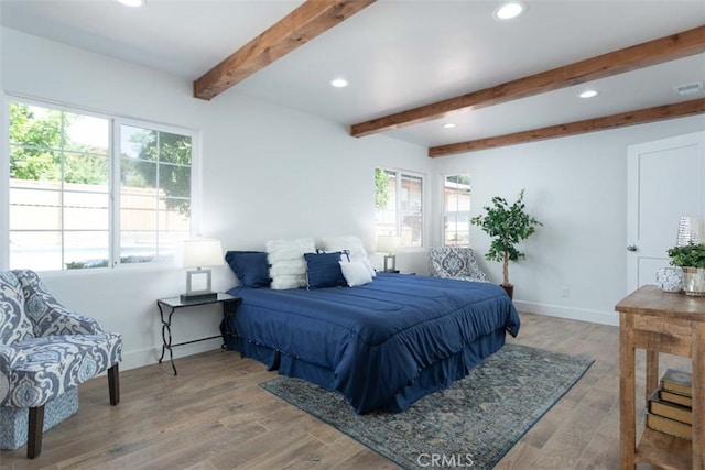 bedroom featuring beam ceiling and hardwood / wood-style floors