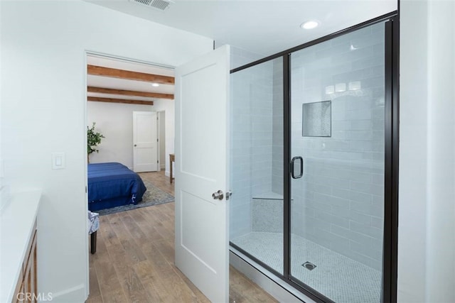 bathroom with hardwood / wood-style floors, an enclosed shower, and vanity