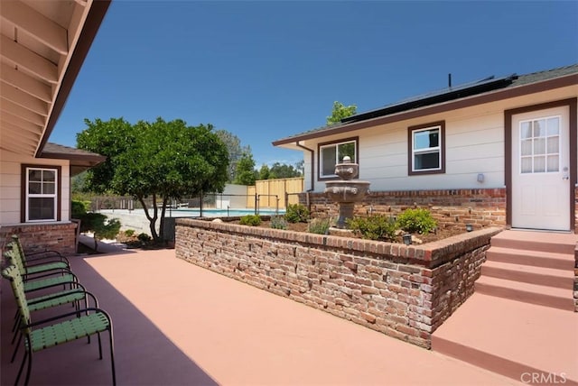 view of patio with a fenced in pool