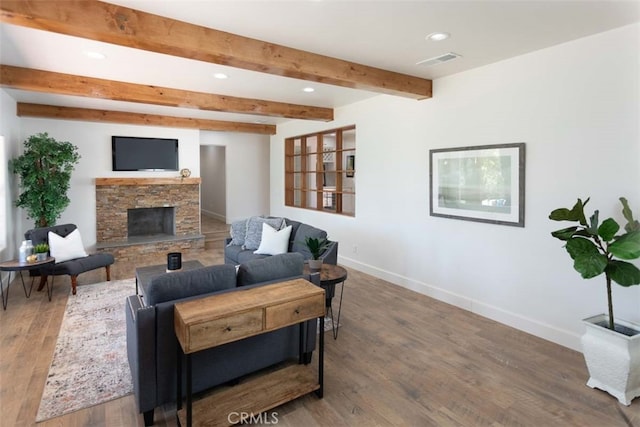 living room featuring a stone fireplace, beam ceiling, and dark hardwood / wood-style floors