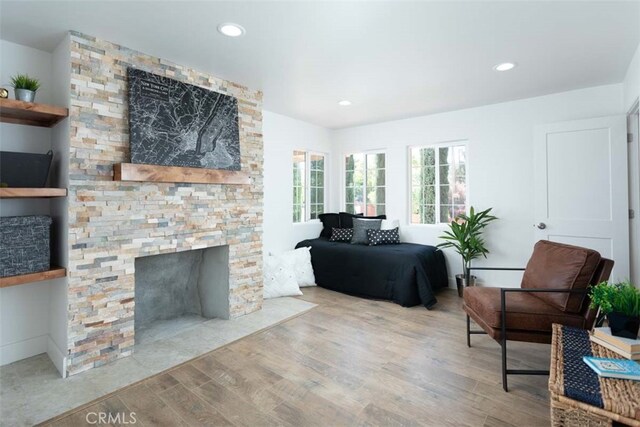 living room with light wood-type flooring and a fireplace