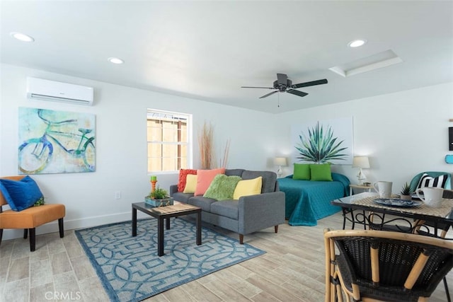 living room featuring light hardwood / wood-style flooring, a wall unit AC, and ceiling fan