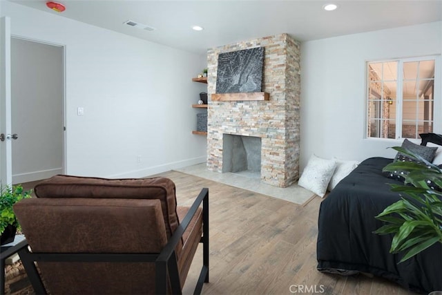 living room featuring a fireplace and light hardwood / wood-style flooring