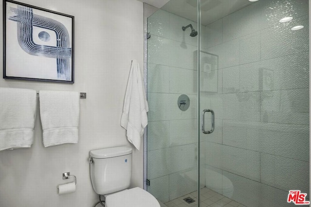 bathroom featuring walk in shower and toilet