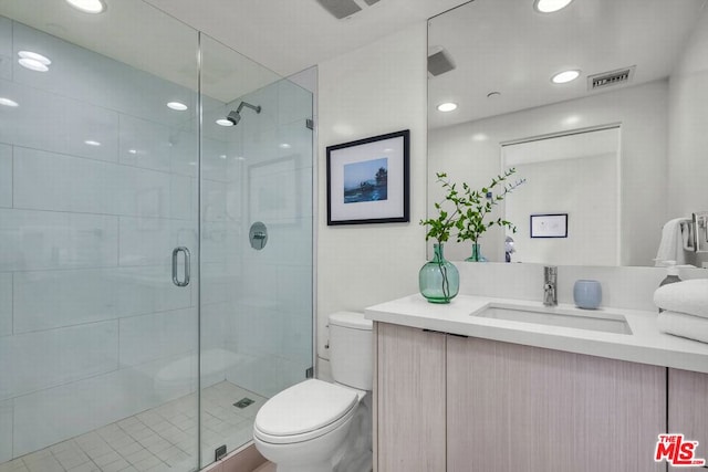 bathroom featuring walk in shower, vanity, and toilet