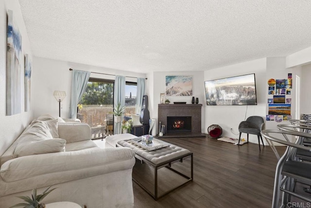 living room featuring dark wood-type flooring and a textured ceiling