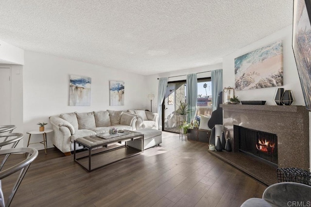 living room featuring dark wood-type flooring and a textured ceiling