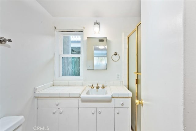 bathroom featuring toilet and vanity