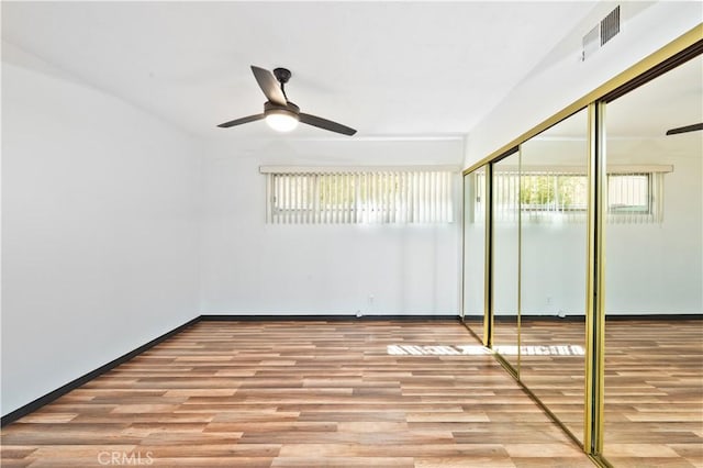 interior space with light wood-type flooring, a closet, and ceiling fan