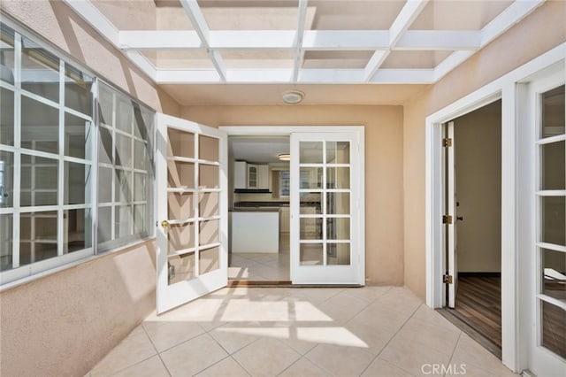 corridor with tile patterned floors and french doors