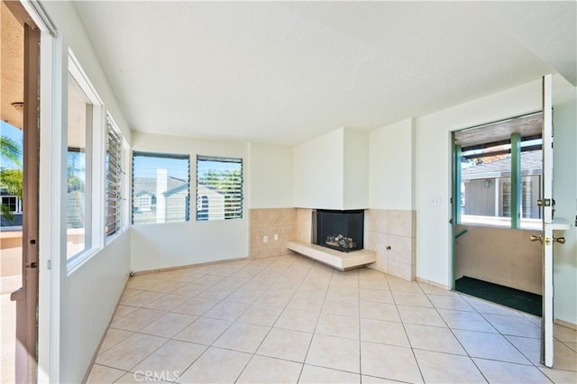 interior space featuring light tile patterned floors and a fireplace