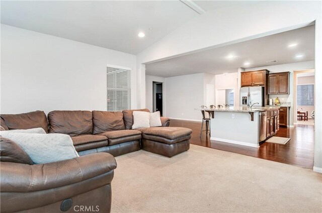 living room with lofted ceiling and dark hardwood / wood-style flooring