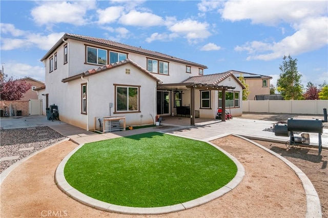 rear view of house with cooling unit, a yard, a pergola, and a patio