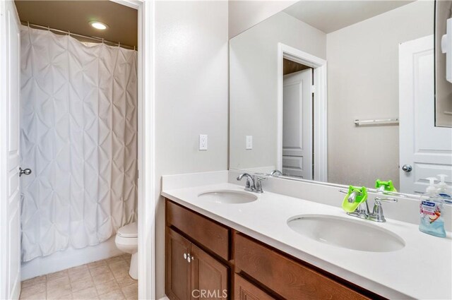 full bathroom with shower / tub combo, vanity, and toilet